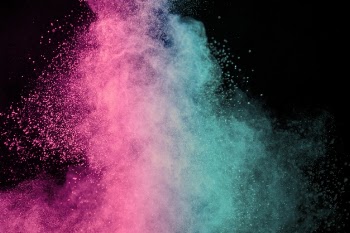Pink and blue explosion of makeup powder on dark background Free Photo