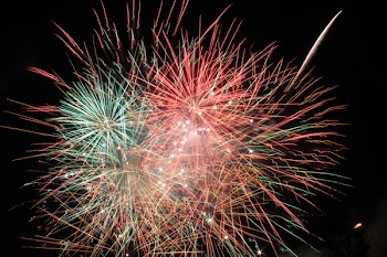 Pink and Green Fireworks Display during Nighttime