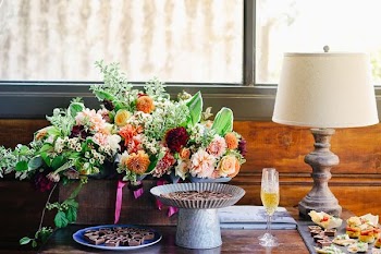 pink and orange flowers in vase near white table lamp