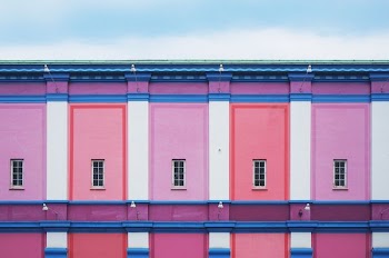 pink and white concrete house under blue sky