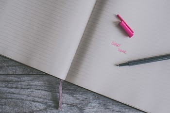 Pink Ballpoint Pen on White Ruled Paper
