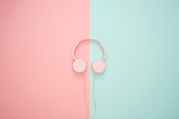 Pink Corded Headphones on pink and teal Wall