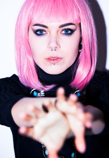 Pink Haired Woman Wearing Black Shirt With Nose And Lip Piercings