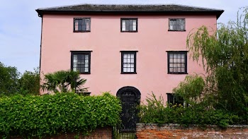 Pink House Facade With Black Gate