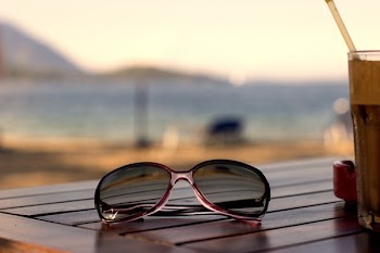 Pink Plastic Framed Wayfarer Sunglasses on Brown Table Top
