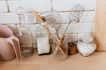 Pink Plastic Pitcher Beside Clear Glass Bottles