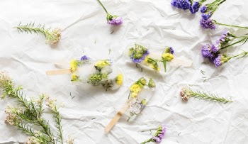 Pink, Purple, and Yellow Flowers on White Textile
