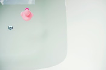 pink rubber duck on bathtub