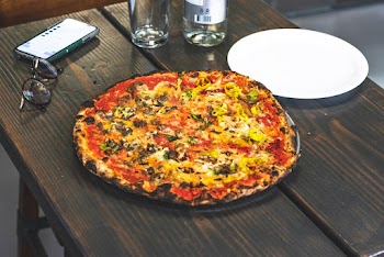 Pizza Served on Table Beside Plate