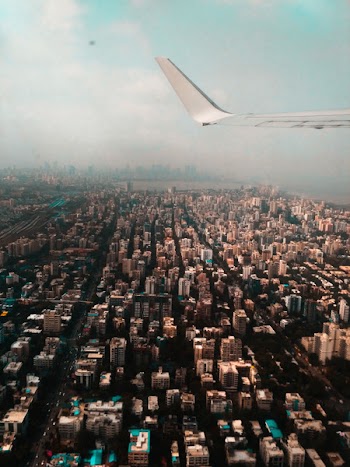 Plane Flying over Buildings
