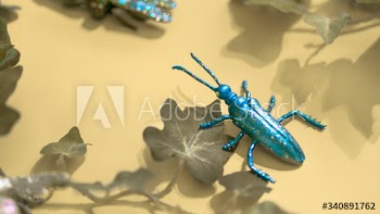 Plastic insect among green leaves