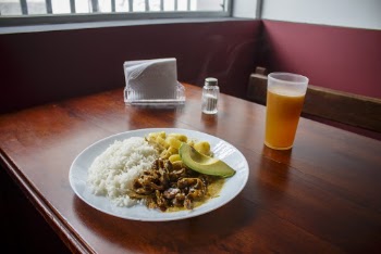 Plate of Cooked Rice With Cooked Beef Beside of Cup of Juice