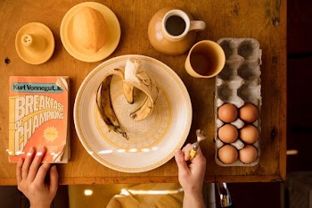 plate with banana and tray of eggs on table