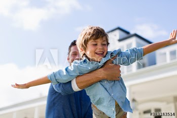 Playful father flying son