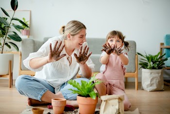 Playful kid potting plant at home as a hobby | Free stock photo | High Resolution image