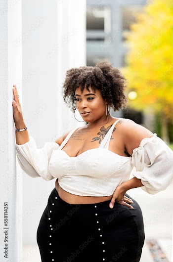 Plus size fashion forward Black woman outside 