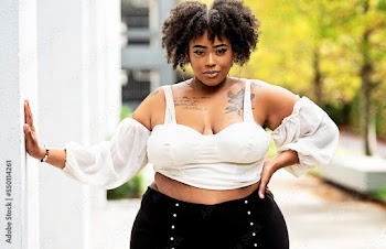 Plus size fashion forward Black woman outside 