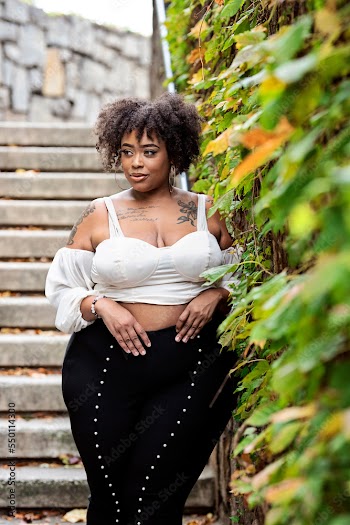 Plus size fashion forward Black woman outside 