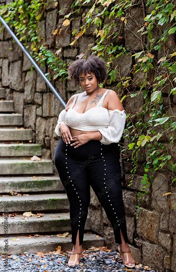 Plus size fashion forward Black woman outside 