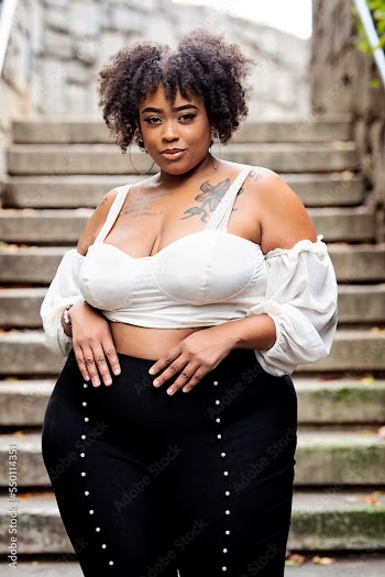 Plus size fashion forward Black woman outside 