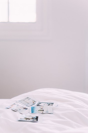 Polaroid Pictures on Bed