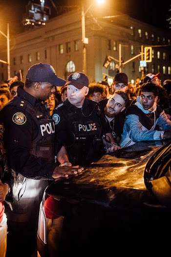Police Men With A Group Of People In A Rally