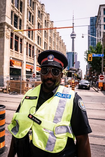 Policeman Standing on Street Near Buildings