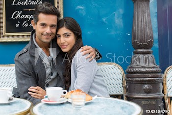 Portrait affectionate couple at sidewalk cafe, Paris, France