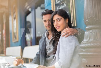 Portrait affectionate couple at sidewalk cafe, Paris, France