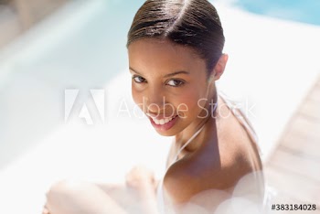Portrait beautiful young woman at sunny poolside