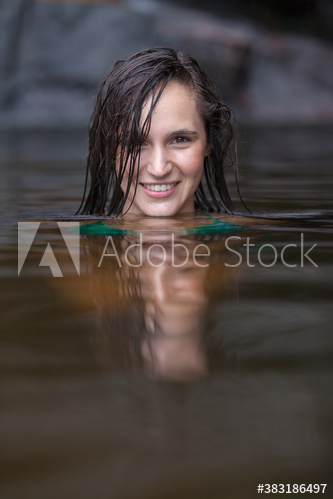 Portrait beautiful young woman swimming in lake