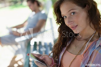 Portrait beautiful young woman using smart phone on park bench