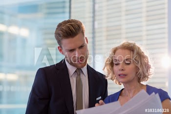 Portrait business people discussing paperwork