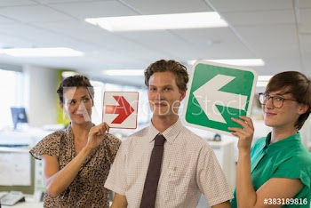 Portrait business people holding arrow signs