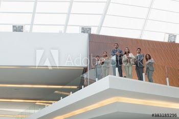 Portrait business people on modern office balcony