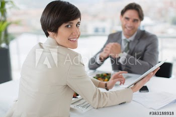 Portrait business people using digital tablet and eating lunch