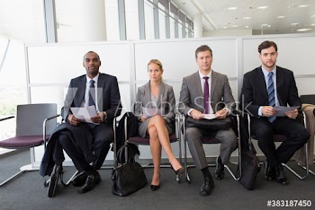 Portrait business people waiting for interview in office lobby