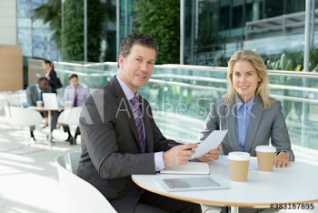 Portrait business people with paperwork meeting in cafe