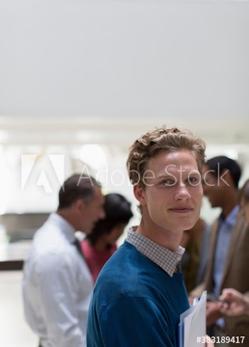 Portrait businessman in office with colleagues