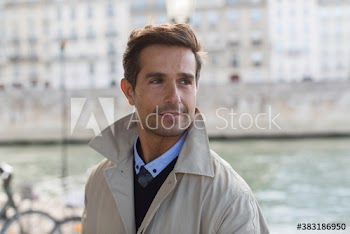 Portrait businessman looking over shoulder, Seine River, Paris