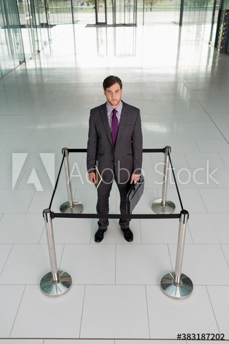 Portrait businessman trapped in stanchions square