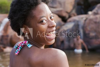 Portrait carefree young woman at lakeside