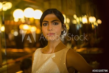 Portrait confident beautiful young woman in cocktail dress