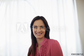 Portrait confident brunette woman at window