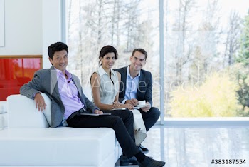Portrait confident business people on sofa