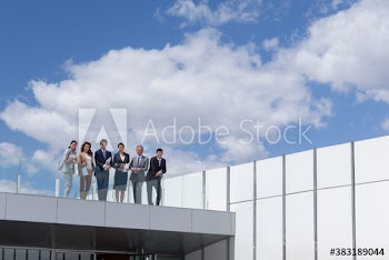 Portrait confident business people on sunny office rooftop