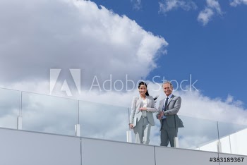 Portrait confident business people on sunny rooftop