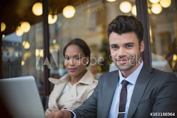 Portrait confident business people working at sidewalk cafe