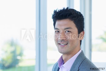 Portrait confident businessman at window