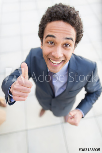 Portrait confident businessman gesturing thumbs up